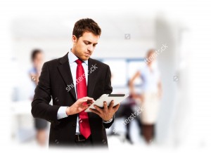 stock-photo-businessman-using-his-tablet-in-the-office-123089410 copie